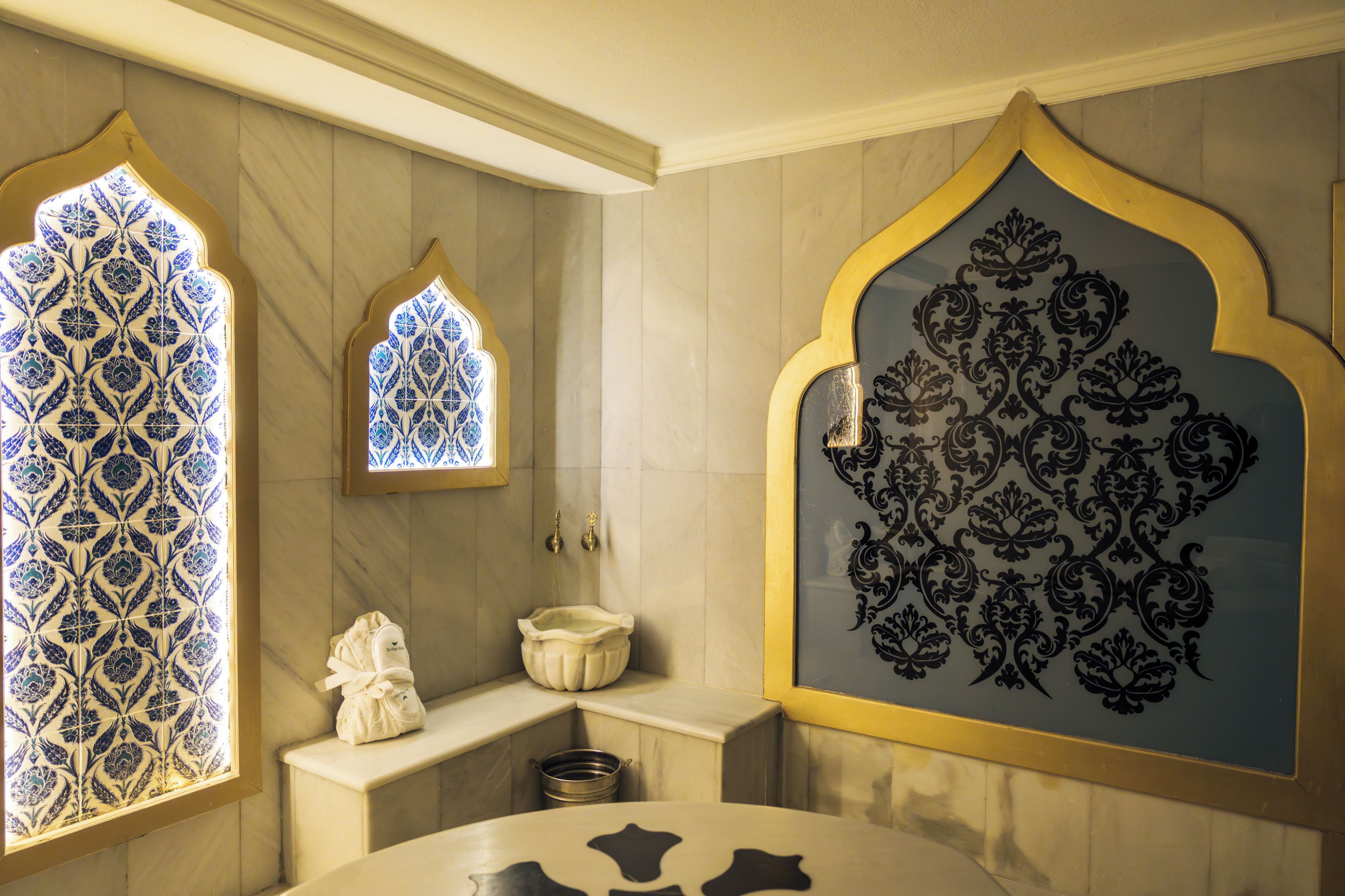 A bathroom with a bathtub, a towel, and a sink.