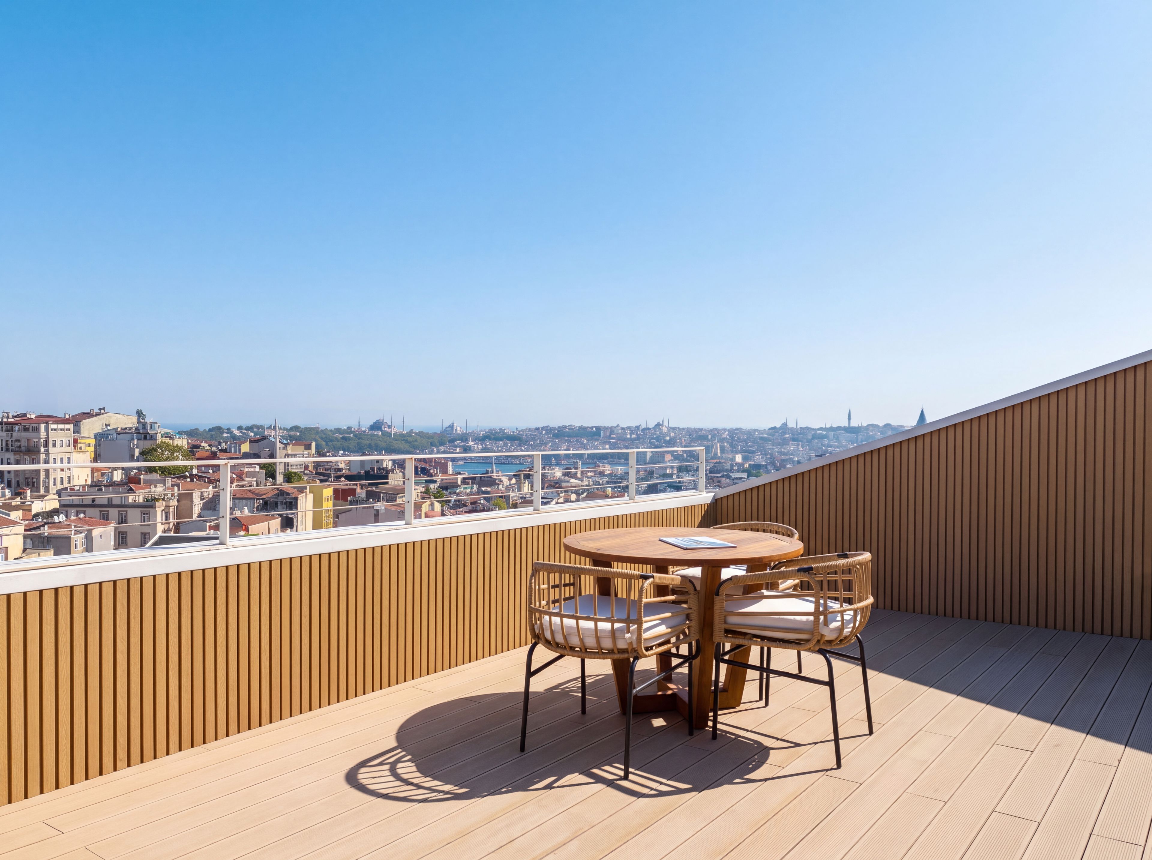 Eine Dachterrasse mit Holzboden, einem runden Tisch und vier Korbstühlen.