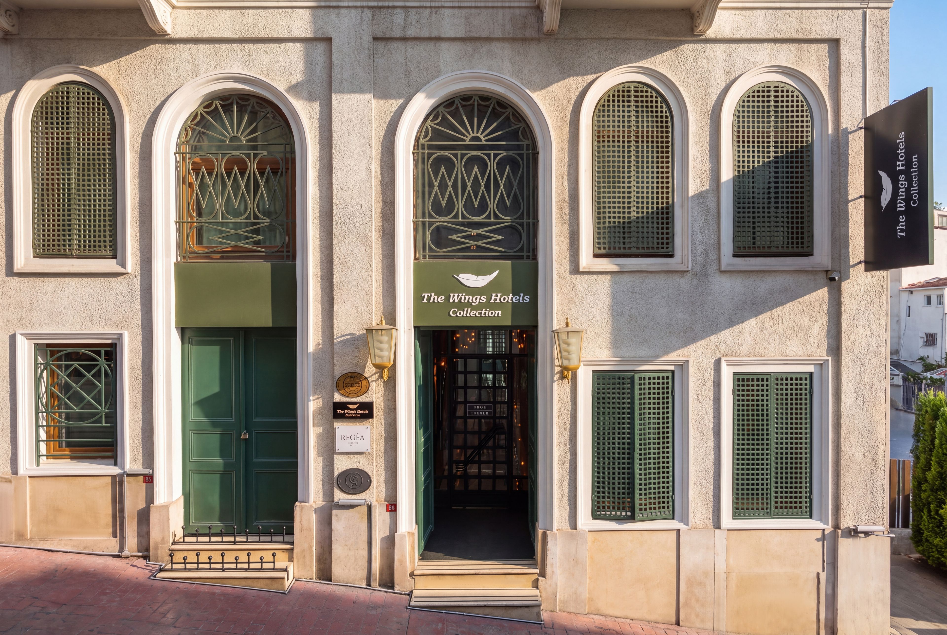 A building with a sign reading 'The Wings Hotels Collection.'