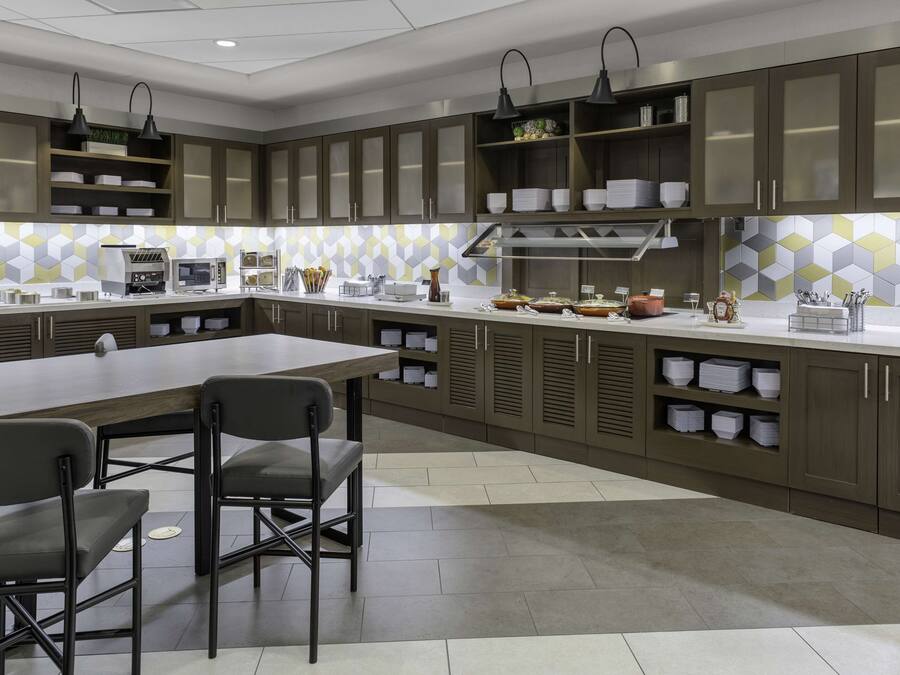 A modern kitchen with a large island, built-in appliances, and ample storage.