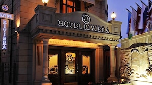 The exterior of Hotel Riviera with its classic architecture, prominent entrance, and illuminated signage. - Riviera Hotel  (Baku)