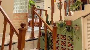 A staircase with wooden balusters and a glass ceiling. - Pousada dos Franceses (São Paulo)
