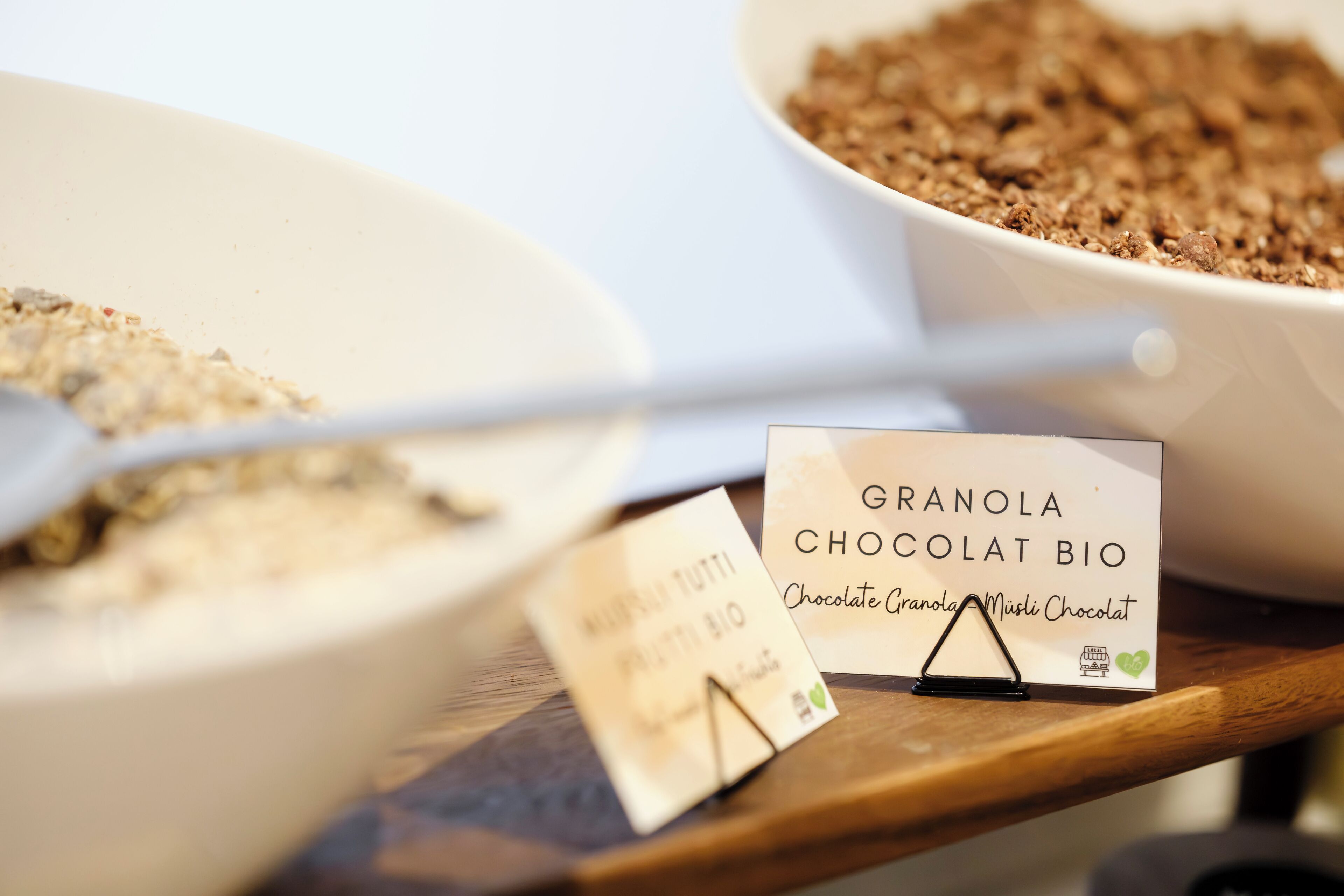 A display of granola and chocolate granola bars with their packaging.