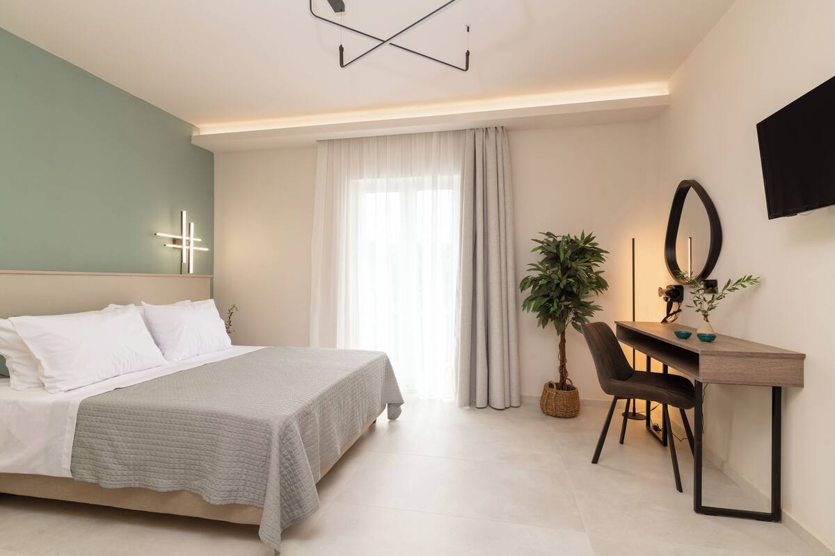 A modern bedroom with a bed, a desk, and a chair.