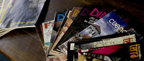 A collection of magazines on a wooden surface.