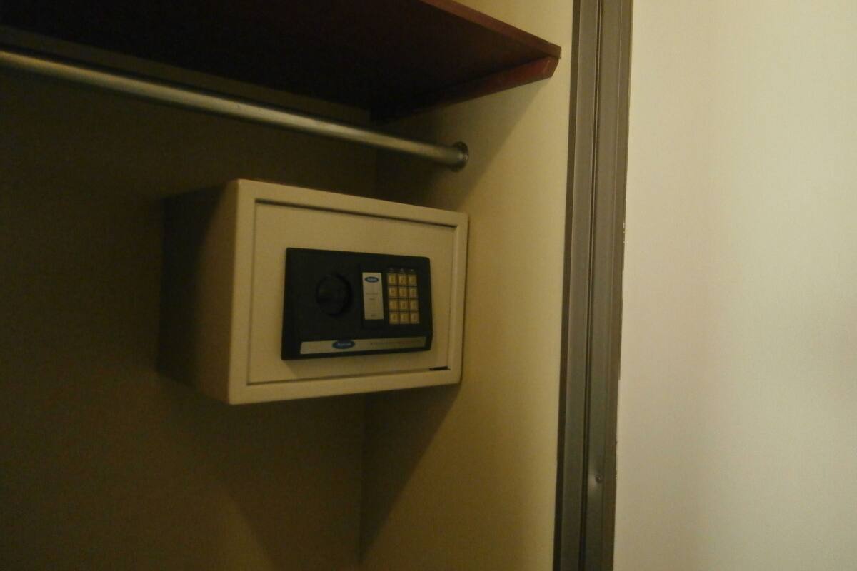 A wall-mounted safe with a keypad and a small display.