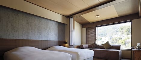 A modern hotel room with two beds, a large window with a view, and a traditional tatami mat floor.
