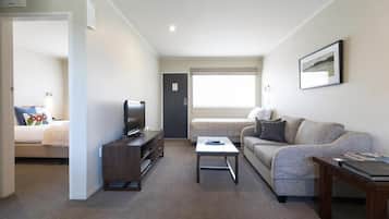 1 Bedroom Unit | Living room | 32-inch flat-screen TV with satellite channels, TV, DVD player