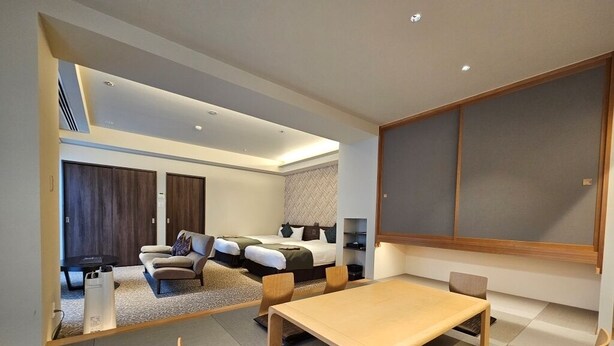 A modern hotel room with a large bed, a sofa, a dining table, and a TV. - Hotel Grand Vert Kyukaruizawa (Karuizawa)