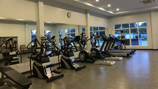 A gym with multiple treadmills, stationary bikes, and a bench. - Myanmar Sports Hotel (Yangon)