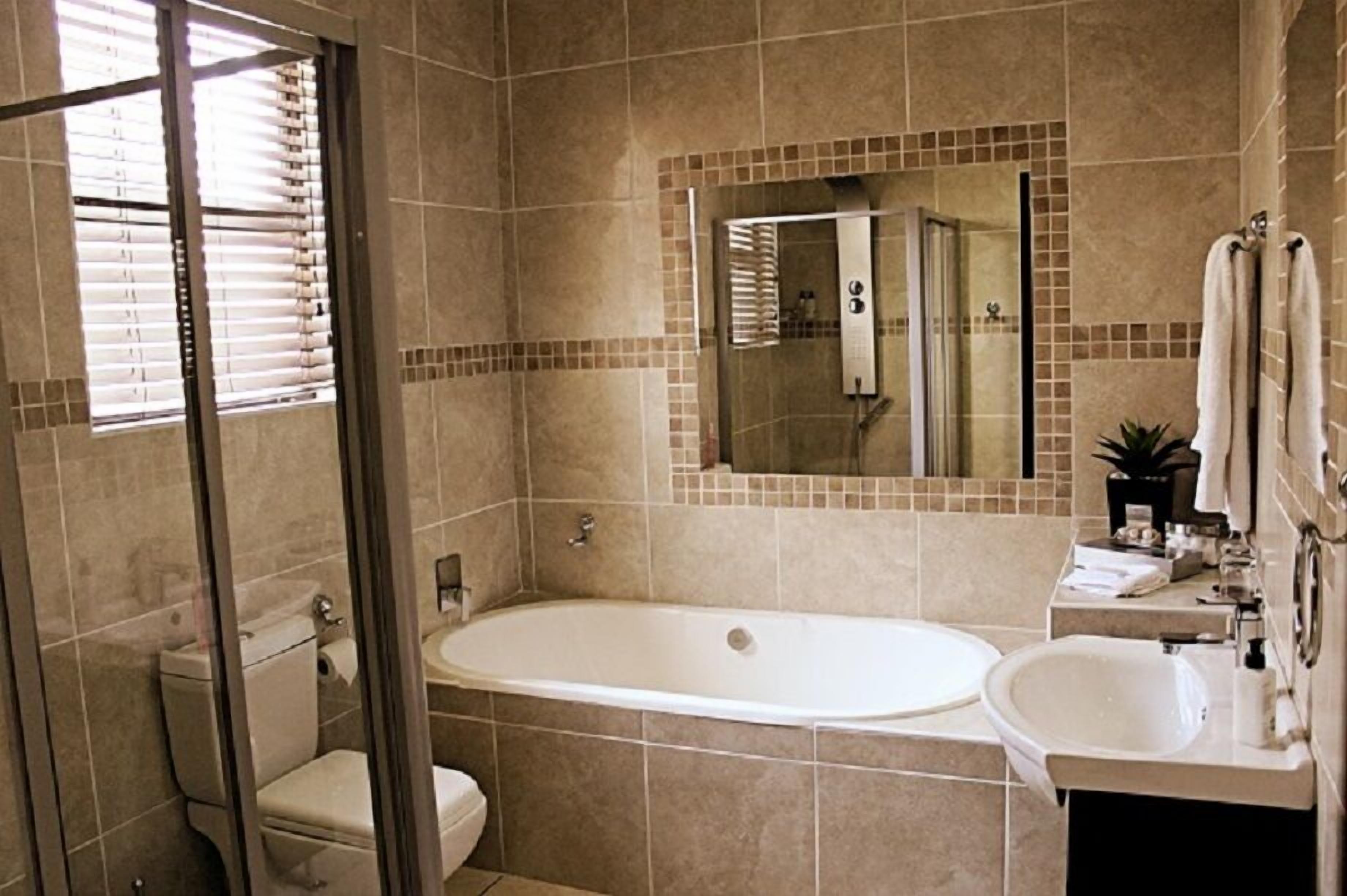 A bathroom with a bathtub, a toilet, a sink, and a shower.