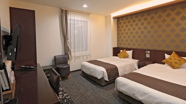 A hotel room with two beds, a desk, a chair, a TV, and a window with curtains. - Hotel Annex Inn (Shinhidaka)