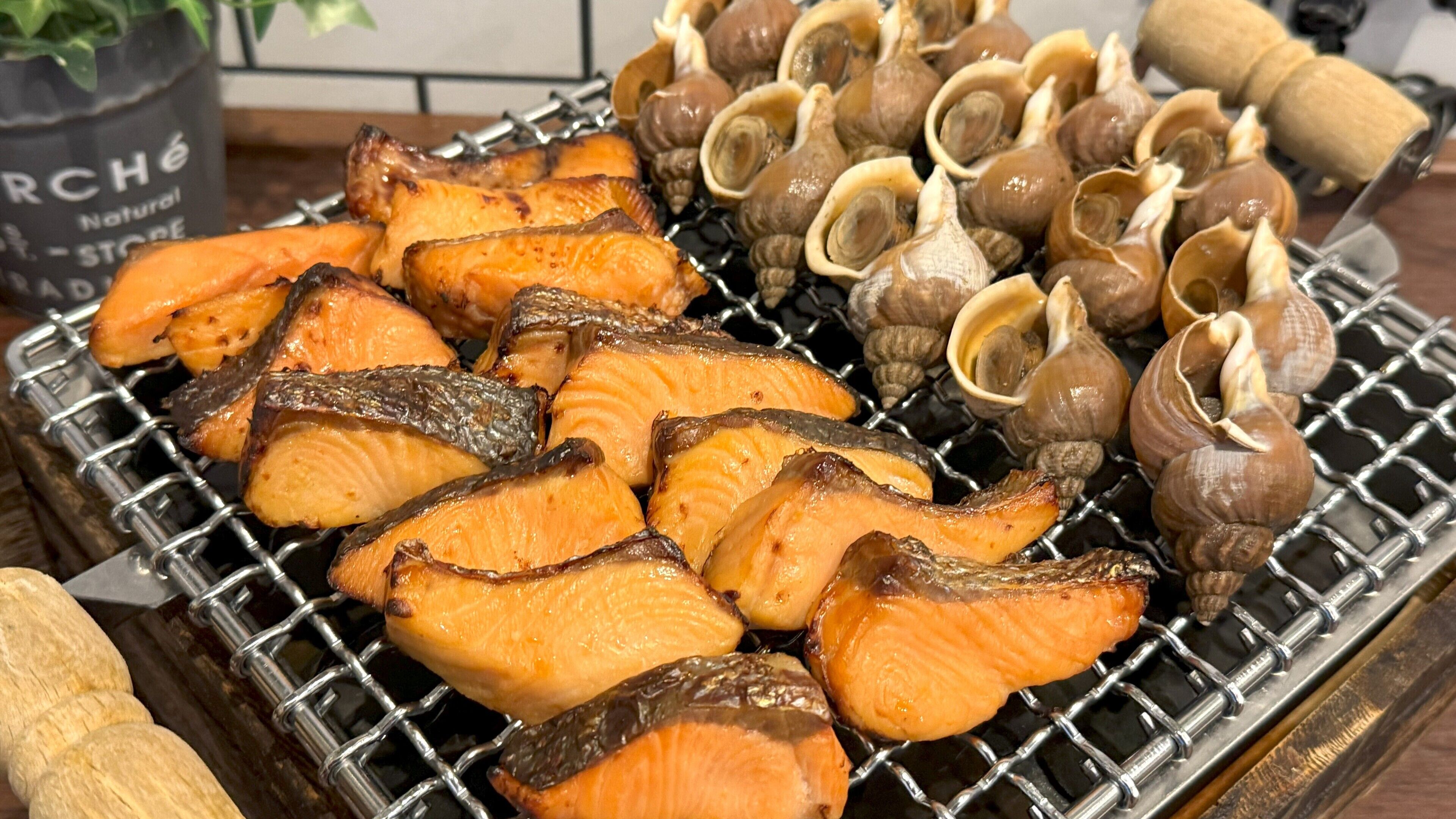 Grilled salmon and clams on a grill.