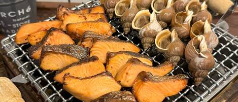 Grilled salmon and clams on a grill.
