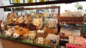 A display of various souvenirs and items, including plush toys, wooden crafts, and packaged goods, arranged on shelves and in baskets.