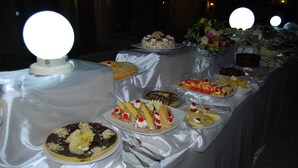 A buffet table with various desserts and a floral arrangement. - Cataract Layalina Resort (Sharm El Sheikh)