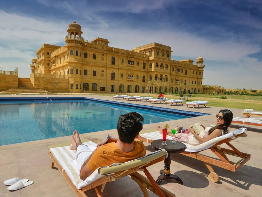 Seasonal outdoor pool, open 7:00 AM to 7:00 PM, pool umbrellas