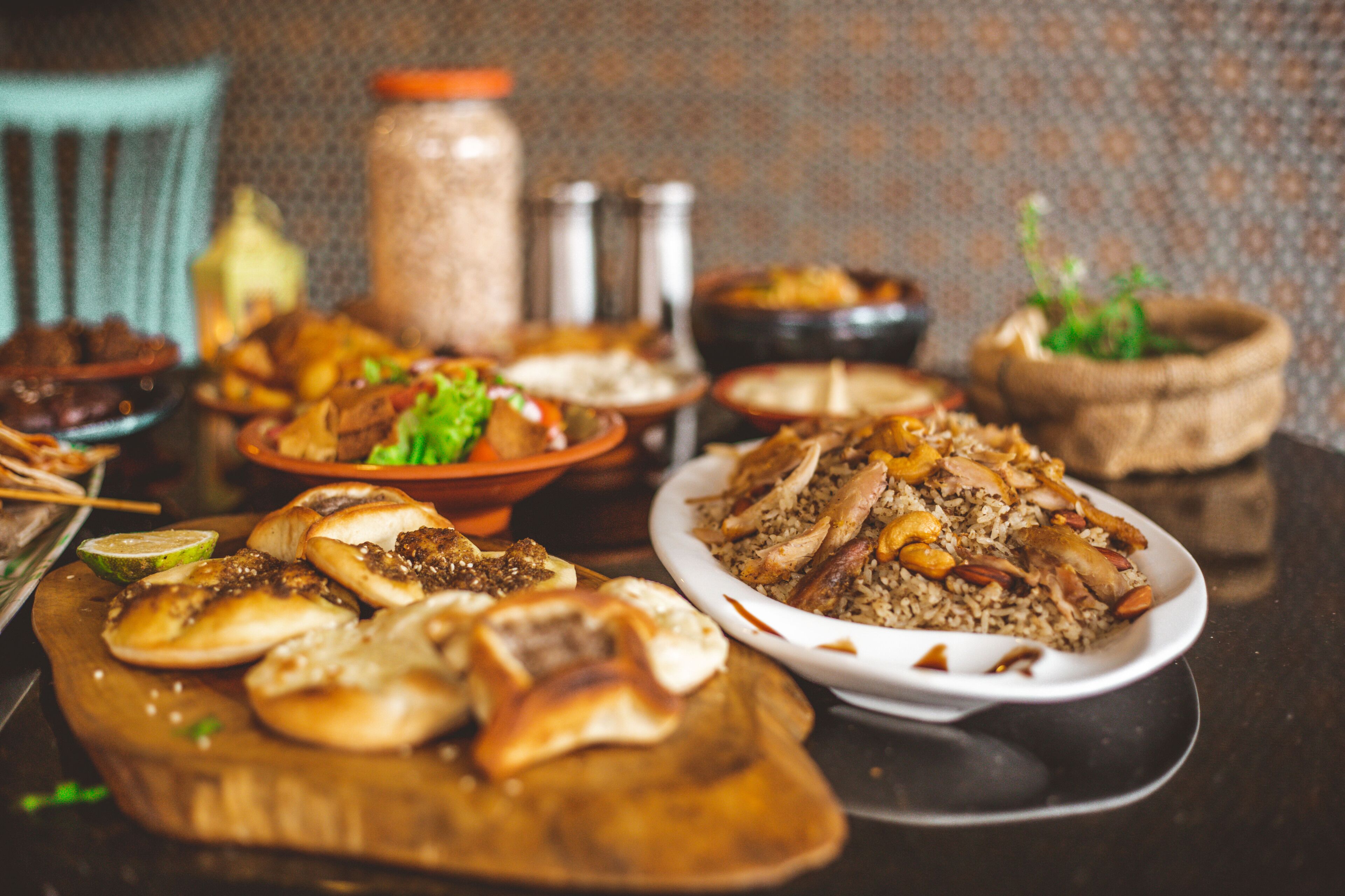 A variety of dishes on a table, including rice, meat, and vegetables.