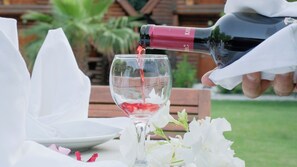 A bottle of wine being poured into a glass. - Woodline Hotel (Kemer)