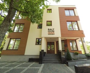 A modern multi-story building with a sign reading "BALT HOUSE APARTAMENTI". - BaltHouse (Jurmala)