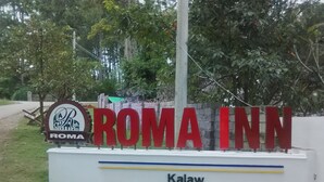 A sign for Roma Inn with a logo and the name 'Roma Inn' in large red letters. - Hostel Roma Inn 2 (Kalaw)