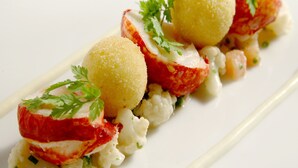 A dish with radishes, cauliflower, and a creamy sauce, garnished with parsley. - Factors Inn & Cottage (Fort William)