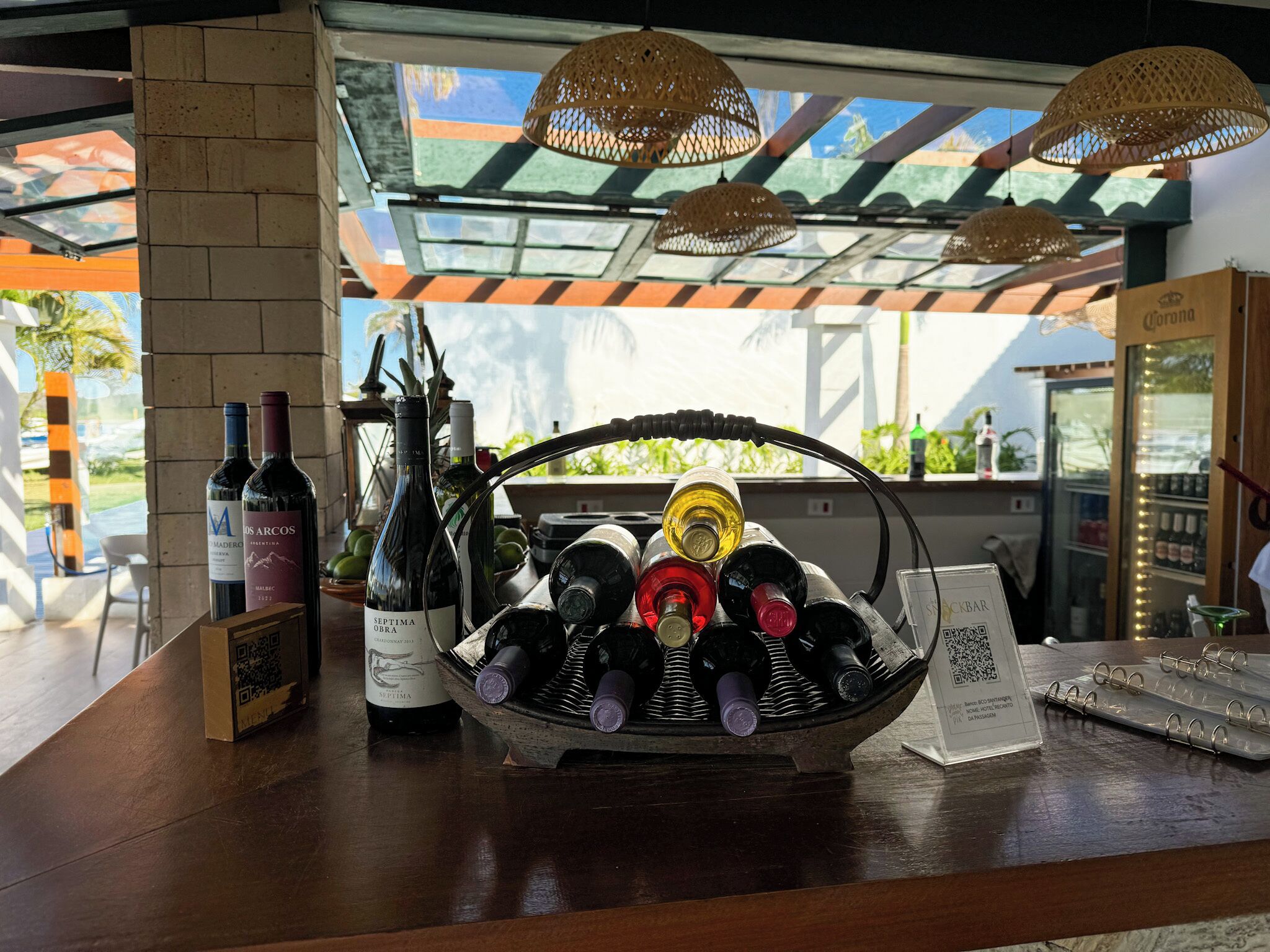 A wine display with bottles and a QR code sign.