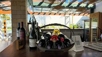 A wine display with bottles and a QR code sign.