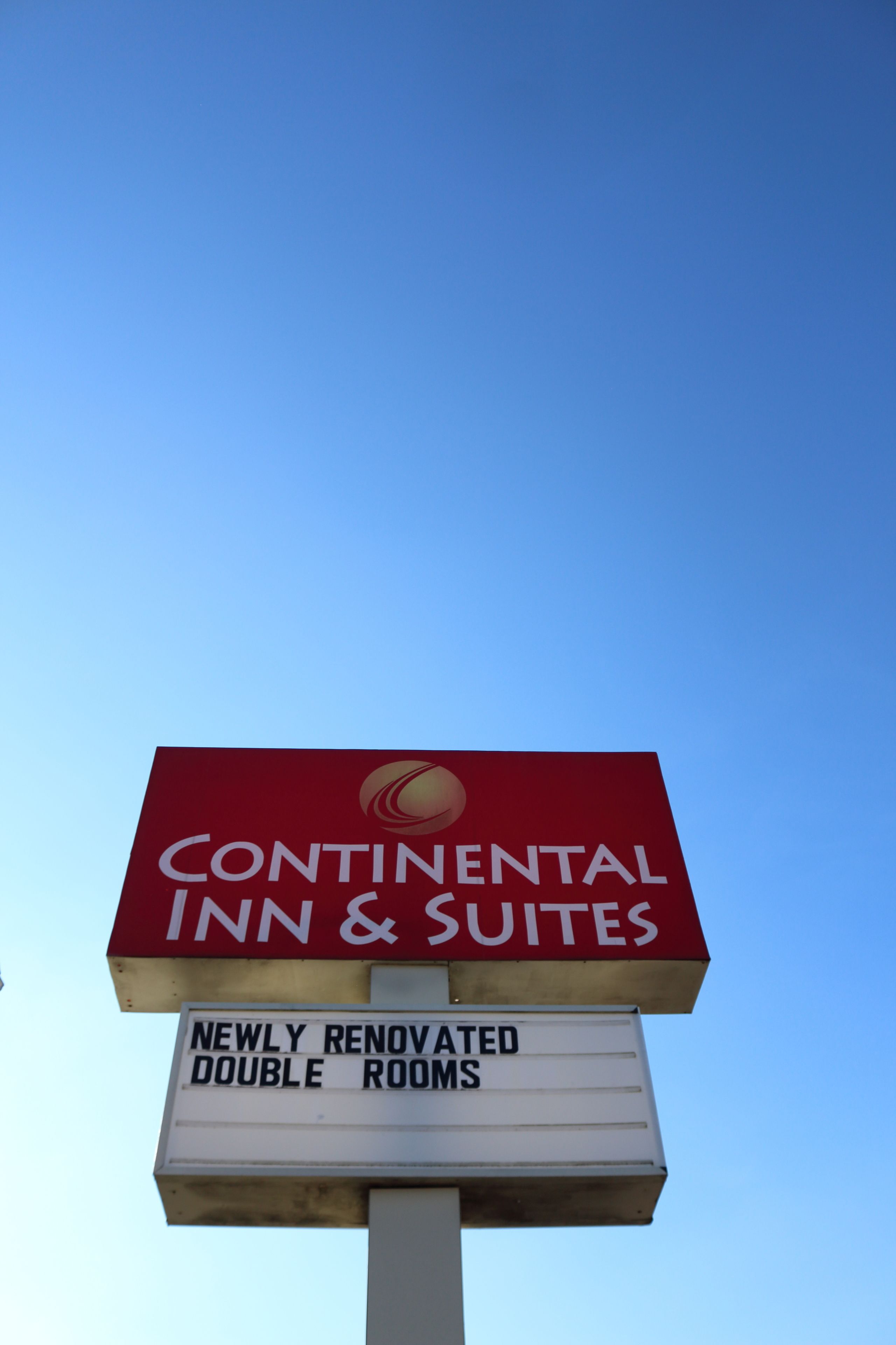 A sign for Continental Inn & Suites advertising newly renovated double rooms.