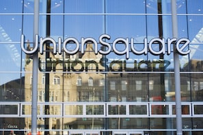 Union Square building features a modern design with large glass windows reflecting the city.