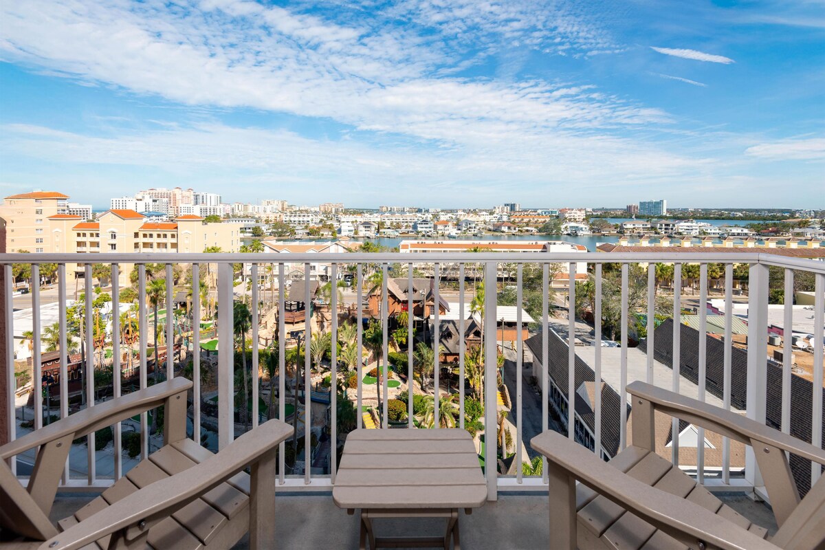 A balcony with a view of a cityscape and a golf course.