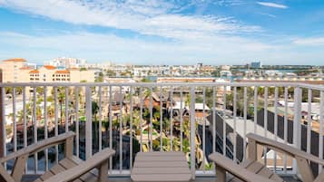 A balcony with a view of a cityscape and a golf course.