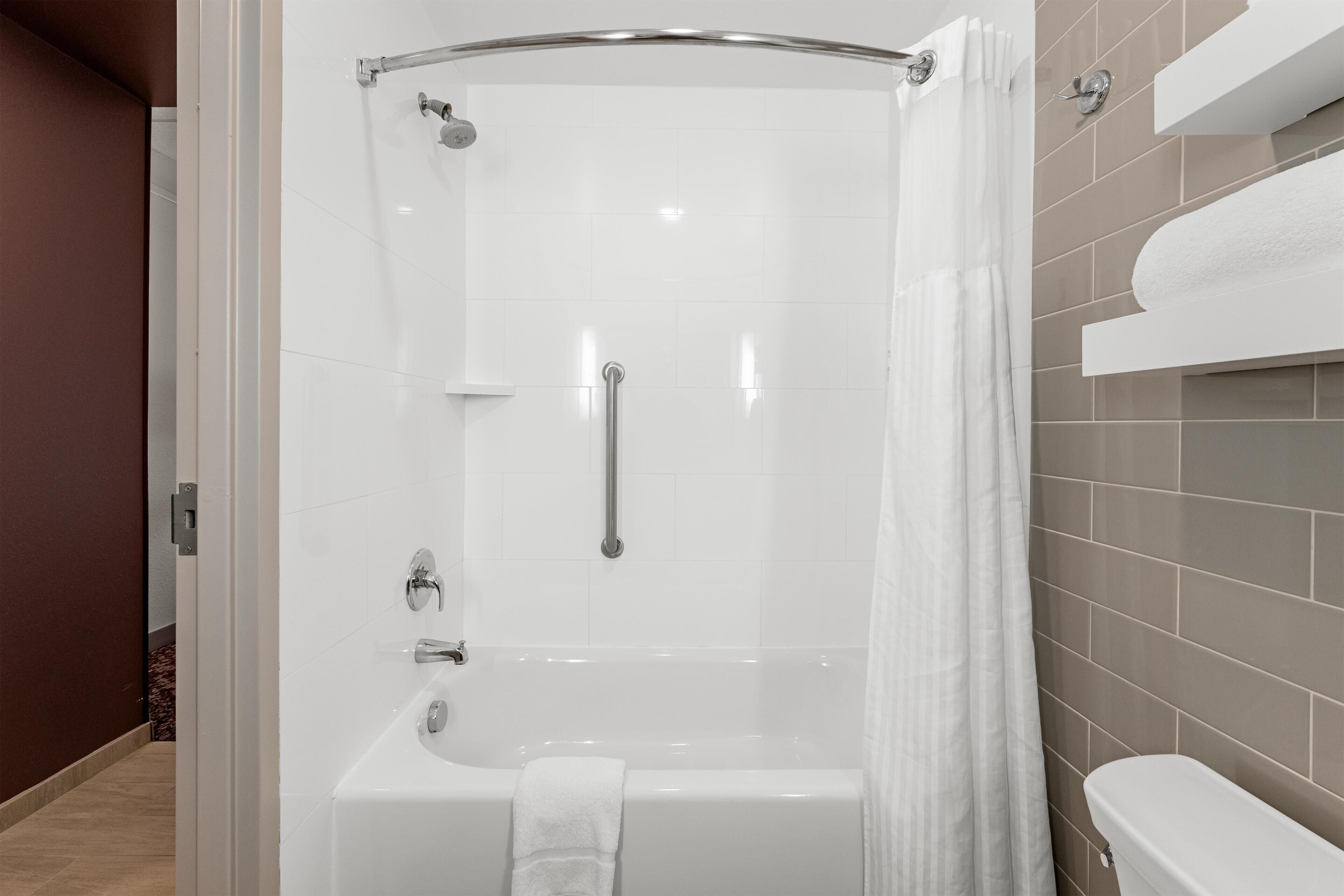 Un baño moderno con cabina de ducha, bañera y retrete.