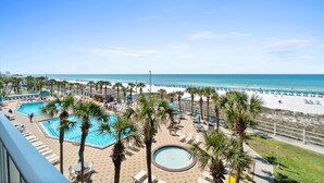 A resort with a pool area, palm trees, and a beach view. - Summit Beach Resort by Panhandle Getaways (Panama City Beach)