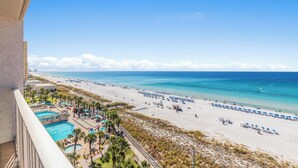 A beach resort with a pool, beach umbrellas, and a clear view of the ocean. - Summit Beach Resort by Panhandle Getaways (Panama City Beach)