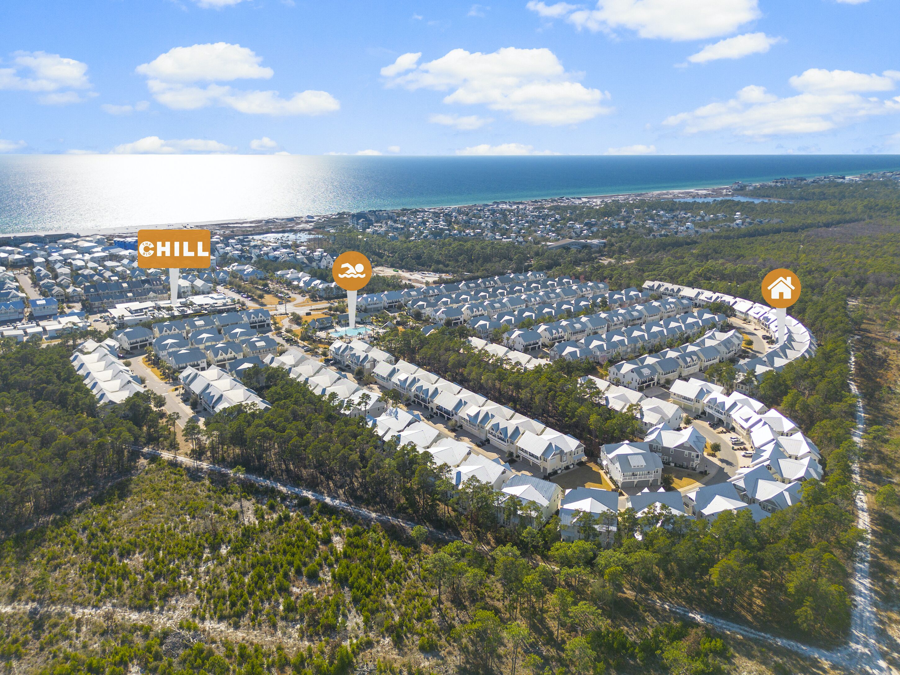 An aerial view of a resort with multiple buildings, a designated 'CHILL' area, and a 'HOME' icon, surrounded by natural landscape and a coastline.