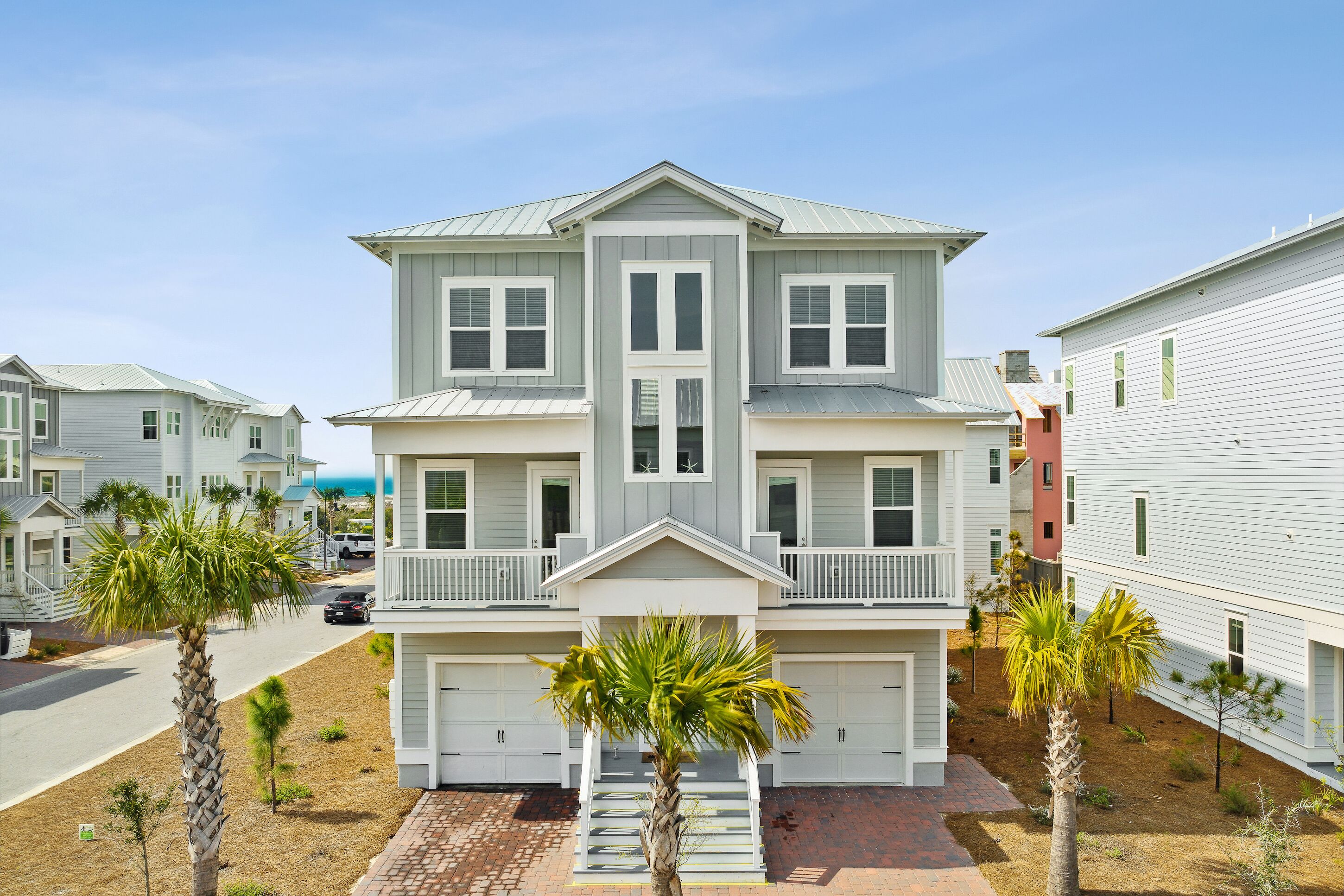 A two-story residential building with a symmetrical facade, a central entrance, and a covered front porch.