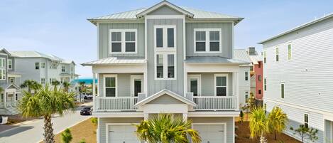 A two-story residential building with a symmetrical facade, a central entrance, and a covered front porch.