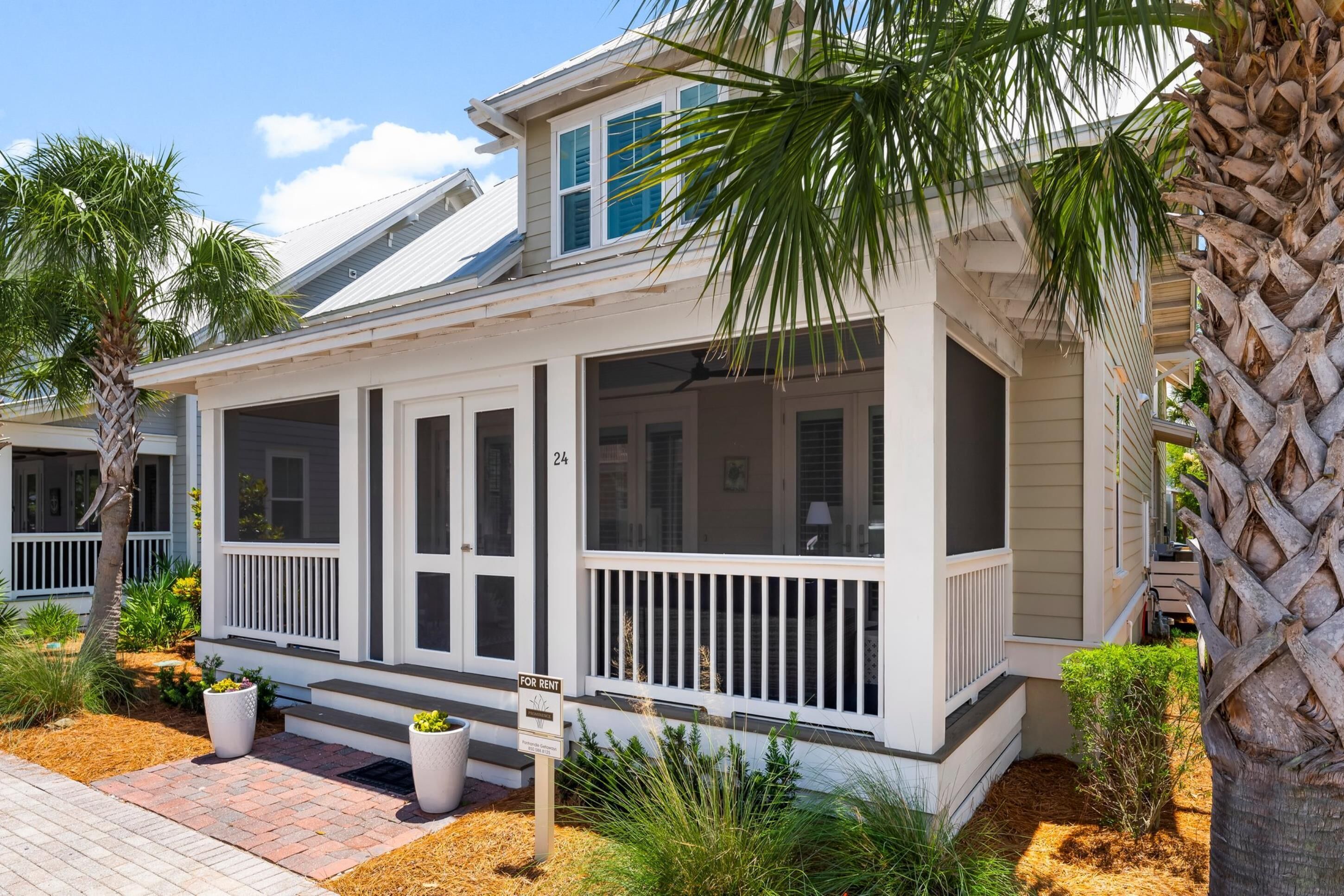 A two-story house with a covered porch, numbered 24, and a 'For Rent' sign.