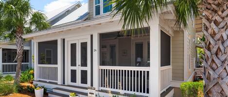 A two-story house with a covered porch, numbered 24, and a 'For Rent' sign.