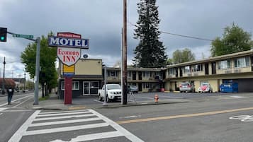A motel with a sign indicating 'Economy Inn' and 'Affordable Rates' at N Shaver St.
