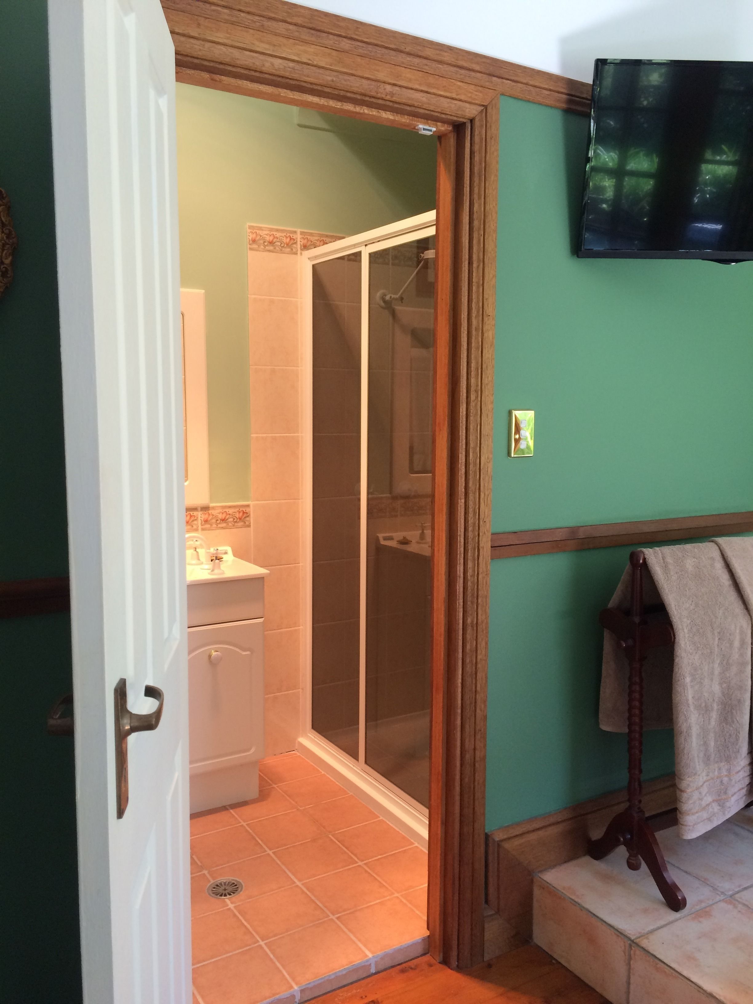 A bathroom with a shower, toilet, and sink.