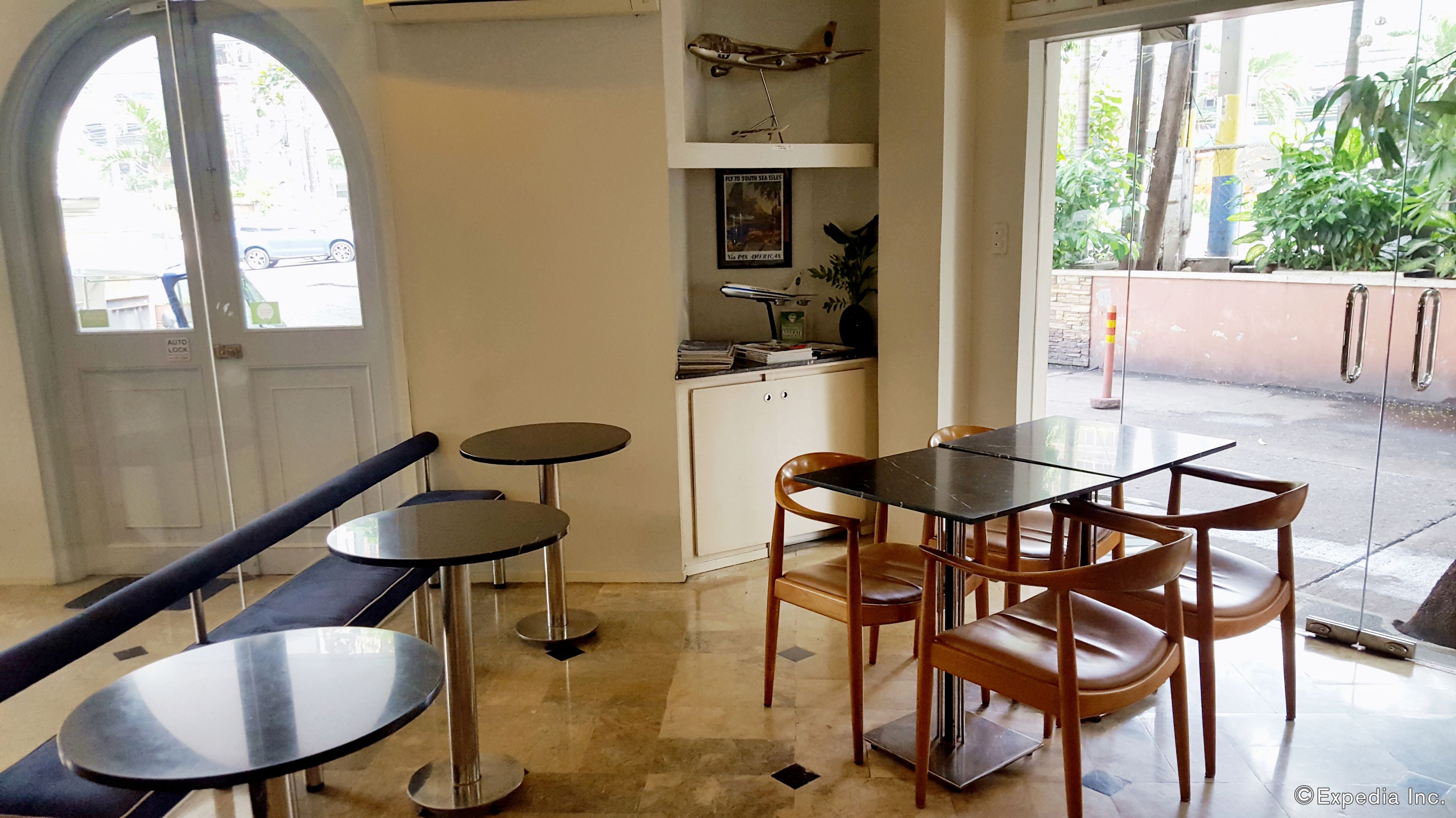 A restaurant interior with a bar area, tables, and chairs.