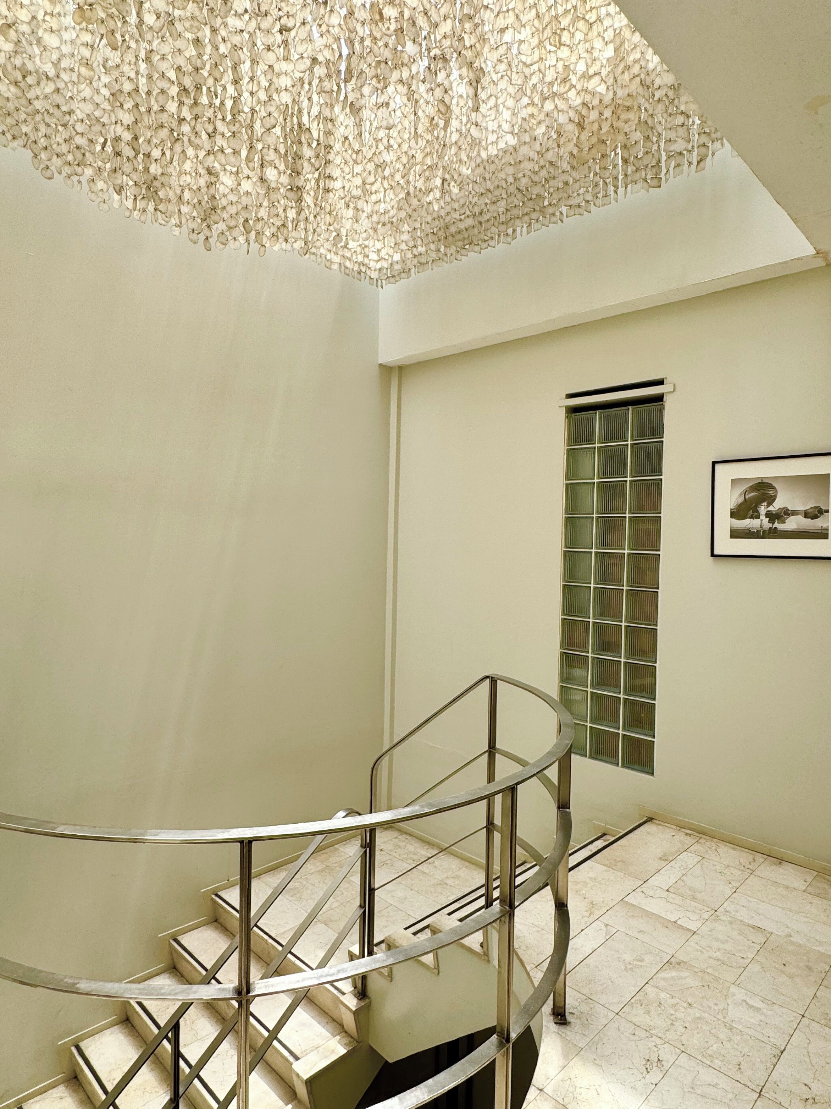 A spiral staircase with metal railings leading to a landing.