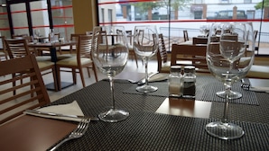 A restaurant table set with wine glasses, cutlery, and salt and pepper shakers. - Hotel Balneario de Graena (Cortes y Graena)