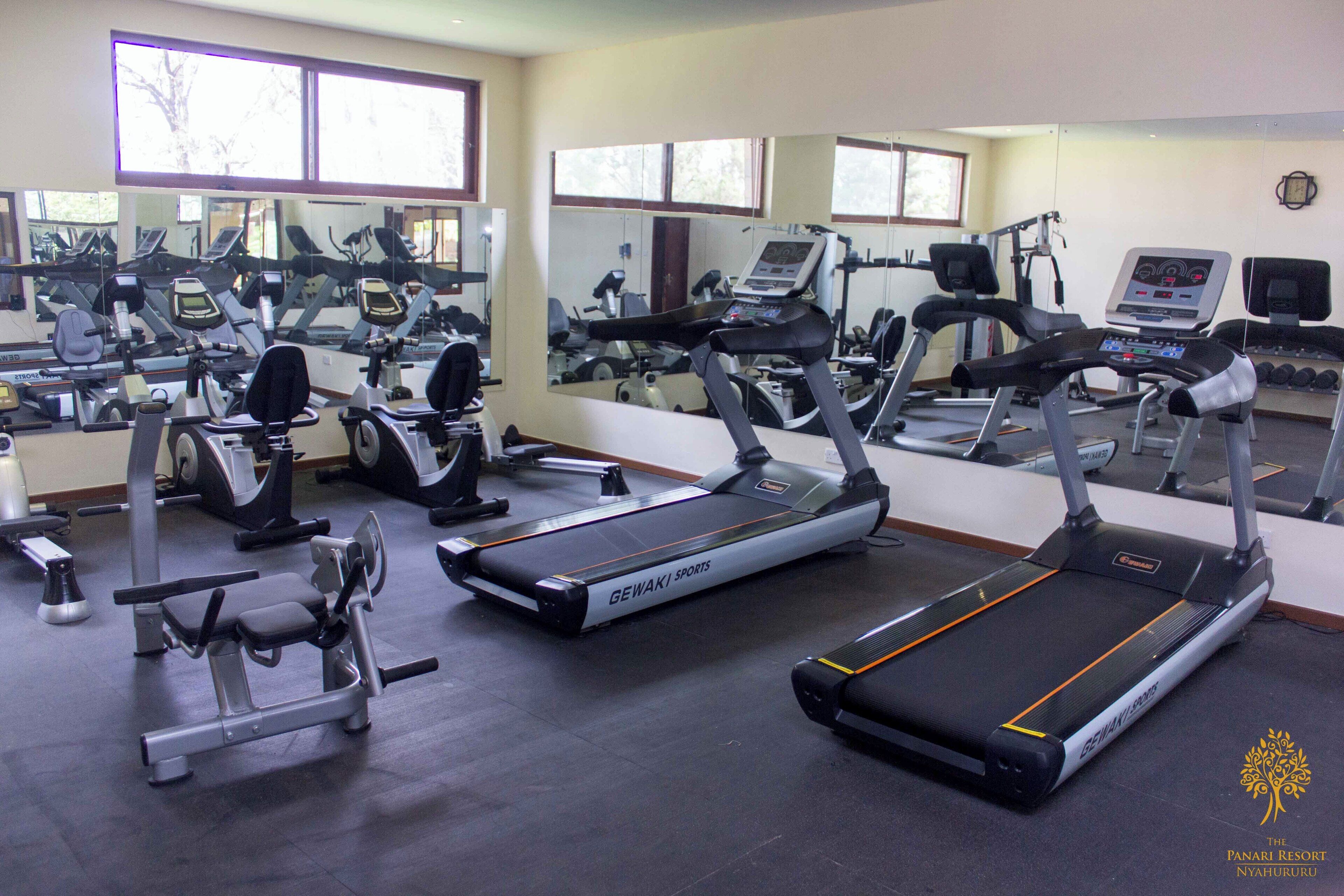 A gym with treadmills, elliptical machines, and weight equipment.