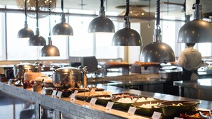 A buffet area with various food stations and hanging pendant lights. - amba Taipei SongShan (Taipei)