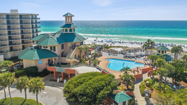 A resort with a pool, beach, and ocean view.