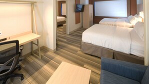 A hotel room with a desk, two beds, a TV, and a large window. - Holiday Inn Express & Suites La Porte by IHG (La Porte)