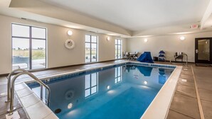 An indoor swimming pool with a clear view of the outside, a metal ladder, and a ceiling with recessed lighting. - Sleep Inn & Suites O'Fallon MO - Technology Drive (O'Fallon)